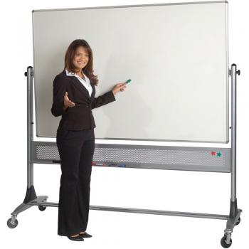 A teacher stands beside a rolling double sided dry erase board.
