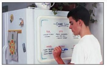 A small dry erase board comes pre installed with hangers, but can also have magnets attached to attach to a door or refrigerator.