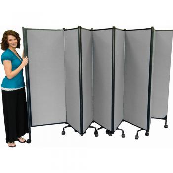 A lady stand beside folding room dividers.