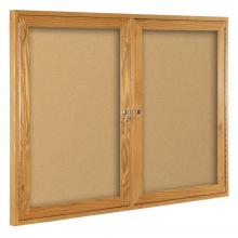A double two door enclosed cork board is shown in oak.