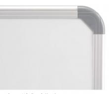 The wall mounted dry erase magnetic board has rounded corners.