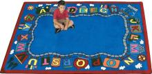 A child is shown sitting on an ABC reading rug surrounded by letter "train cars".